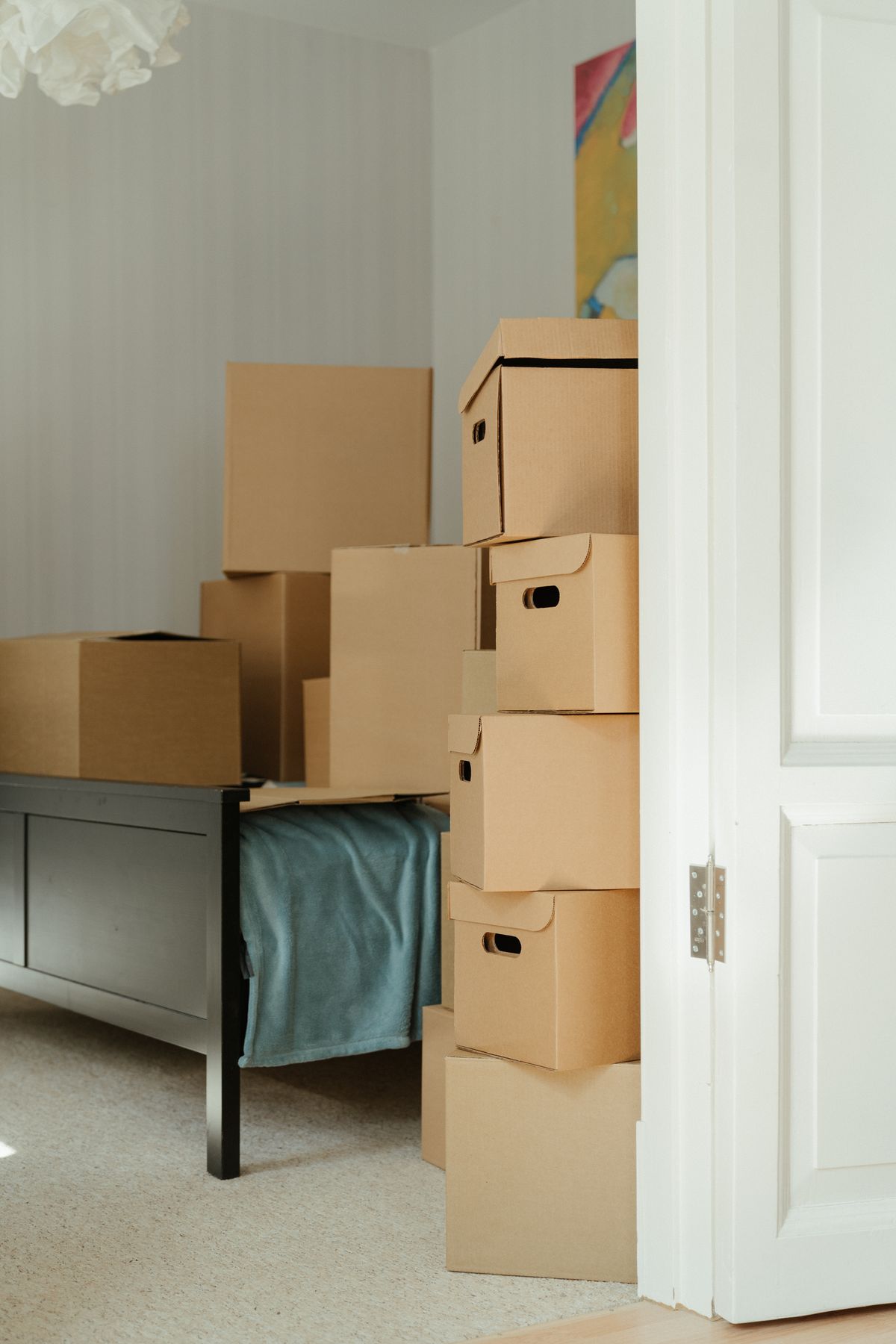 A stack of moving boxes near a window